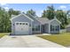 Attractive single-story home with light blue siding, a two-car garage, and a green lawn at 437 Shallow Cove Dr., Conway, SC 29527