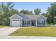 Charming single story home featuring a blue exterior, attached garage, and well-maintained lawn at 437 Shallow Cove Dr., Conway, SC 29527