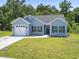 Charming single-story home with light blue siding, a well-manicured lawn, and an attached one-car garage at 437 Shallow Cove Dr., Conway, SC 29527