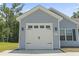 A two-car garage door with sidelights and a number '437' on the home's exterior at 437 Shallow Cove Dr., Conway, SC 29527