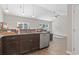 Modern kitchen featuring granite countertops, stainless steel appliances, and an open layout flowing into the living room at 437 Shallow Cove Dr., Conway, SC 29527