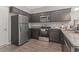Modern kitchen featuring granite countertops, stainless steel appliances, and dark wood cabinetry at 437 Shallow Cove Dr., Conway, SC 29527