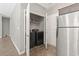 Convenient laundry room with stainless steel appliances, shelving, and ample storage space at 437 Shallow Cove Dr., Conway, SC 29527