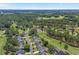 Wide aerial shot capturing the house in a neighborhood surrounded by lush greenery and golf courses at 4709 National Dr., Myrtle Beach, SC 29579