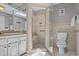 Elegant bathroom featuring tiled walls, a glass-enclosed shower with seat, and a vanity with ample counter space at 4709 National Dr., Myrtle Beach, SC 29579