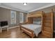 Cozy bedroom with a bunk bed, natural light, and wooden floors offering a warm and inviting atmosphere at 4709 National Dr., Myrtle Beach, SC 29579