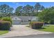 Charming single-Gathering home featuring a manicured front lawn, driveway, garage, and welcoming facade at 4709 National Dr., Myrtle Beach, SC 29579