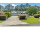 Beautiful one-story home with a well-manicured front yard and a charming water fountain at 4709 National Dr., Myrtle Beach, SC 29579