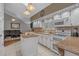 Bright kitchen and living room featuring granite countertops, white cabinetry, and appliances at 4709 National Dr., Myrtle Beach, SC 29579