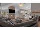 Open-concept living space with a stone fireplace, flowing into a modern, bright kitchen area at 4709 National Dr., Myrtle Beach, SC 29579