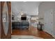 Open-concept living area featuring a vaulted ceiling, brick fireplace, and hardwood flooring throughout at 4709 National Dr., Myrtle Beach, SC 29579