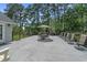Large patio with outdoor seating, umbrella and wrought iron fence backing to trees at 4709 National Dr., Myrtle Beach, SC 29579