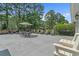 Rear patio featuring outdoor seating, dining area with umbrella, and view of landscaped backyard at 4709 National Dr., Myrtle Beach, SC 29579