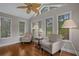 Sun-filled sun room with hardwood floors, large windows, and two comfortable chairs at 4709 National Dr., Myrtle Beach, SC 29579