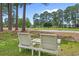 Well-manicured lawn with bench seating overlooking green spaces and mature trees at 4709 National Dr., Myrtle Beach, SC 29579