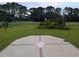 Large backyard with a view of the golf course, a patio, and mature landscaping at 4719 National Dr., Myrtle Beach, SC 29579