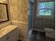 Stylish bathroom with patterned wallpaper, white vanity, a modern mirror, and walk in shower at 4719 National Dr., Myrtle Beach, SC 29579