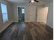 Spacious bedroom featuring wood-look flooring, neutral paint, and access to an ensuite bath and closet at 4719 National Dr., Myrtle Beach, SC 29579