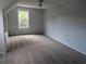 Bright bedroom with neutral walls, plush carpet, and a ceiling fan for optimal comfort at 4719 National Dr., Myrtle Beach, SC 29579