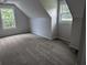 Neutral bedroom featuring carpet, two large windows, and angled ceilings offering ample natural light at 4719 National Dr., Myrtle Beach, SC 29579