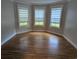 Bedroom with hardwood flooring, and a bay window offering natural light and views of the outdoors at 4719 National Dr., Myrtle Beach, SC 29579