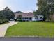 Beautiful home with a lush green lawn and curved driveway leading up to a well-maintained property at 4719 National Dr., Myrtle Beach, SC 29579
