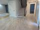 Open foyer with tiled floors and a staircase, leading to other rooms with hardwood flooring at 4719 National Dr., Myrtle Beach, SC 29579