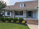 Inviting front porch with wooden posts and manicured bushes leading to the front door at 4719 National Dr., Myrtle Beach, SC 29579