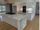 Bright kitchen features a large center island with marble countertops, white cabinets, and stainless appliances at 4719 National Dr., Myrtle Beach, SC 29579
