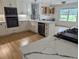 Open kitchen boasts marble countertops, stainless appliances, white cabinetry, and a bright dining area at 4719 National Dr., Myrtle Beach, SC 29579