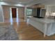 Open concept kitchen with white cabinets, marble countertops, stainless appliances, and hardwood floors at 4719 National Dr., Myrtle Beach, SC 29579