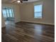 Open living room with hardwood flooring, large window offering natural light, and views of additional rooms at 4719 National Dr., Myrtle Beach, SC 29579