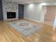 Cozy living room showcasing a gray stone fireplace, hardwood floors, and neutral wall paint at 4719 National Dr., Myrtle Beach, SC 29579