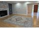 Bright living room with wood floors, a stone fireplace, and a colorful area rug at 4719 National Dr., Myrtle Beach, SC 29579