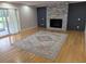 Inviting living room with a modern gray stone fireplace, hardwood floors, and sliding glass doors at 4719 National Dr., Myrtle Beach, SC 29579