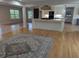 Inviting living space flowing into a kitchen area, featuring hardwood floors and natural lighting at 4719 National Dr., Myrtle Beach, SC 29579