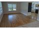 Bright living space showcasing hardwood floors and large windows bringing in natural light at 4719 National Dr., Myrtle Beach, SC 29579