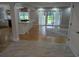 Bright open-concept living space with wood floors connecting the kitchen to a room with sliding doors at 4719 National Dr., Myrtle Beach, SC 29579