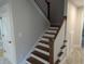 Elegant staircase features wood treads, white risers and spindles, and a stained wood handrail at 4719 National Dr., Myrtle Beach, SC 29579