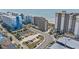 Aerial view of condos along the beach with street access and adjacent parking at 4719 S Ocean Blvd. # 108, North Myrtle Beach, SC 29582