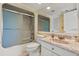 Bathroom featuring shower with sliding glass door, single sink with granite top, and large mirror at 4719 S Ocean Blvd. # 108, North Myrtle Beach, SC 29582