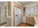 Bright kitchen with wood floors and cabinets, white fridge and dishwasher, and a window over the sink at 4719 S Ocean Blvd. # 108, North Myrtle Beach, SC 29582