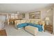 Open-concept living room with a sectional sofa and breakfast bar leading to the kitchen at 4719 S Ocean Blvd. # 108, North Myrtle Beach, SC 29582