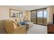Inviting living room with ocean views, a comfortable sofa, and large windows for natural light at 4719 S Ocean Blvd. # 108, North Myrtle Beach, SC 29582