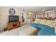 Cozy living room with a TV, a breakfast bar and an open view of the kitchen and dining area at 4719 S Ocean Blvd. # 108, North Myrtle Beach, SC 29582
