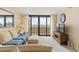 Comfortable living room featuring a blue sofa, large windows with ocean views, and stylish decor at 4719 S Ocean Blvd. # 108, North Myrtle Beach, SC 29582