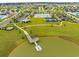 Stunning aerial view of community amenities including pool, tennis courts, and dock overlooking the lake at 5087 Sundrop Ln., Little River, SC 29566