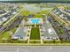 Expansive aerial view of the neighborhood showcasing its resort-style pool, amenity center, and lush landscaping at 5087 Sundrop Ln., Little River, SC 29566