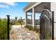 Beautiful outdoor space with stone pathway, wrought iron gate, and a view of the screened in porch at 5087 Sundrop Ln., Little River, SC 29566