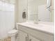 Clean bathroom featuring a grey vanity, mirror, and a shower with a white curtain at 5087 Sundrop Ln., Little River, SC 29566